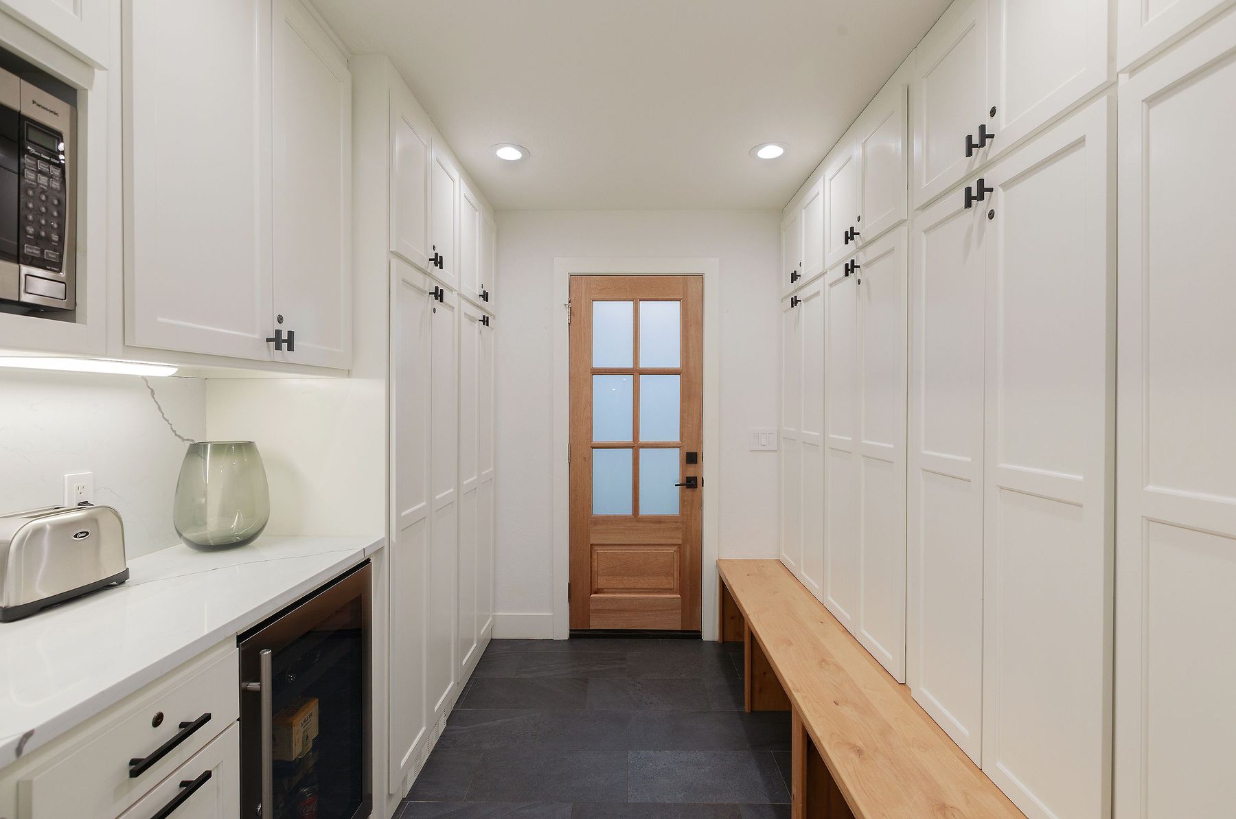 Mudroom with built-in storage and bench