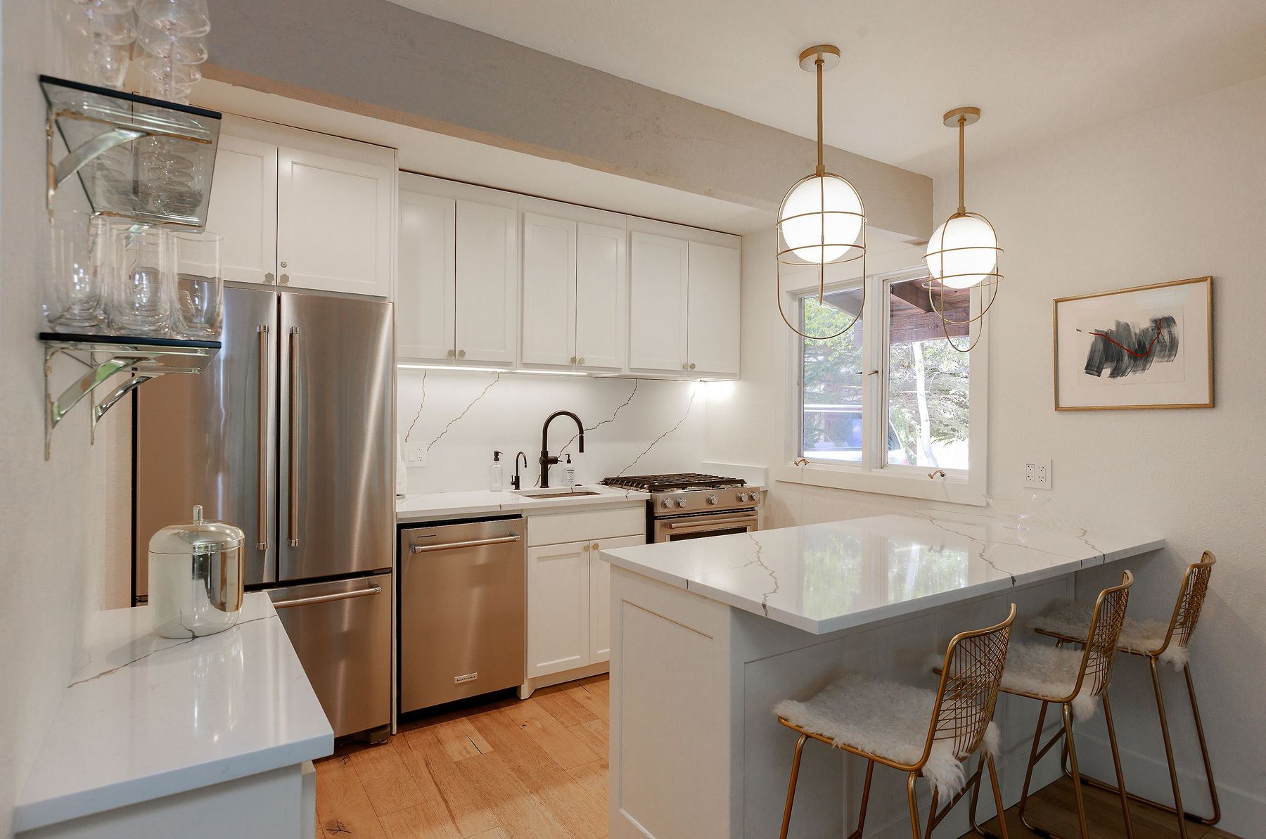 Gas range, custom cabinetry, brass fixtures