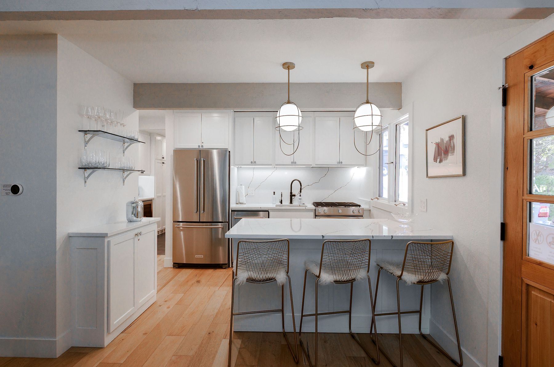 Renovated kitchen with quartz waterfall island