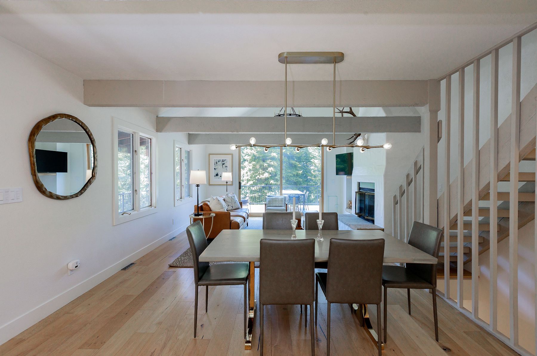 Dining table beneath sculptural chandelier