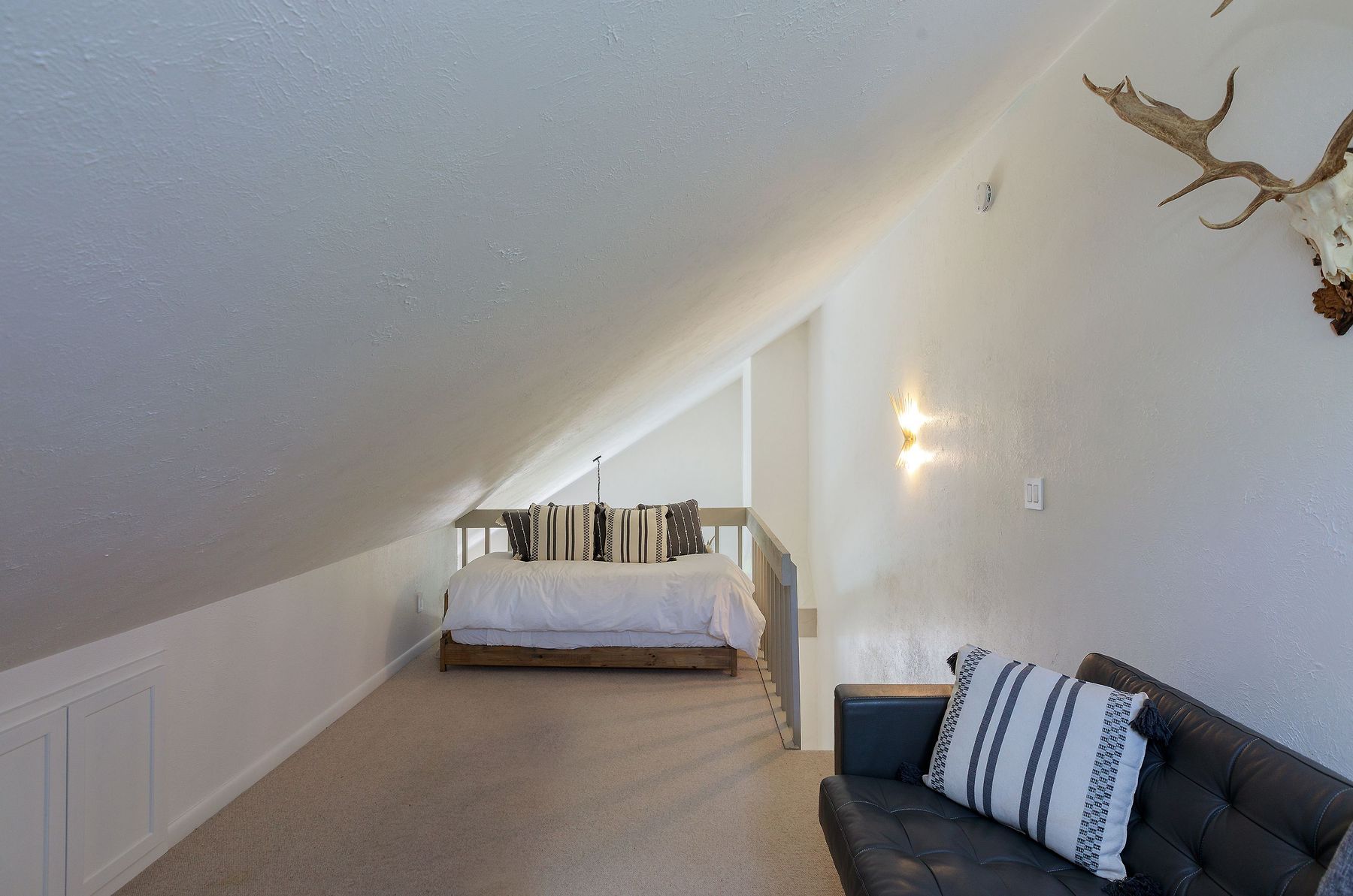 Loft sleeping nook tucked under the eaves